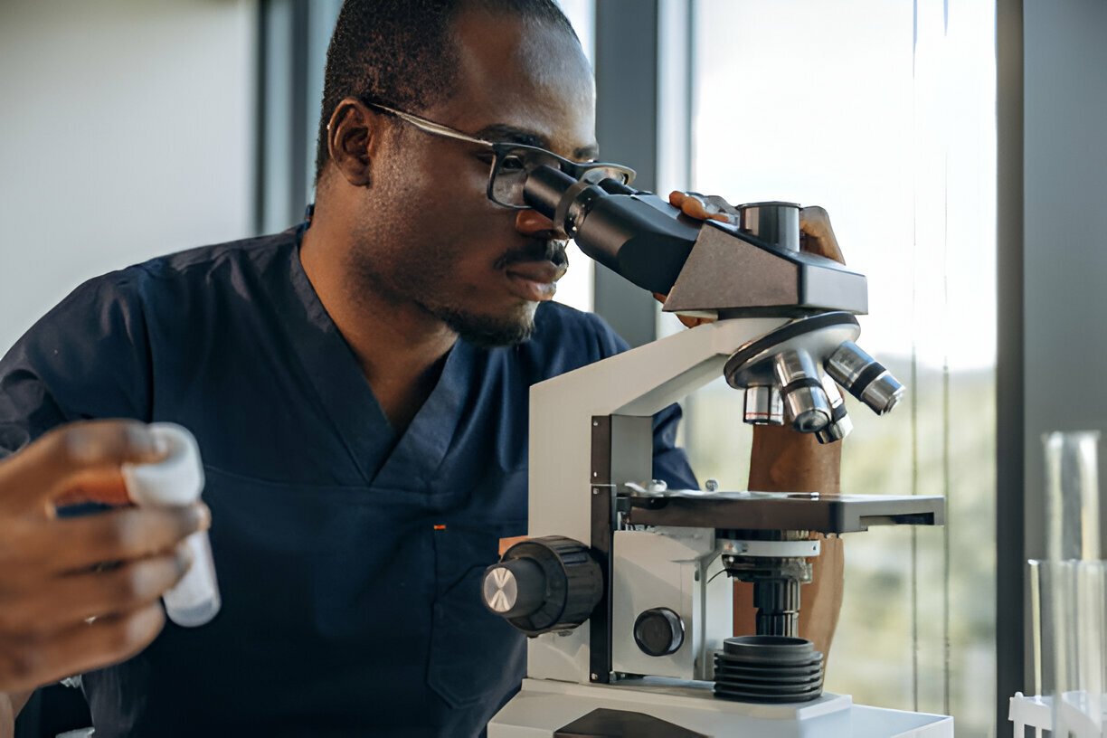 Lab technician with microscope