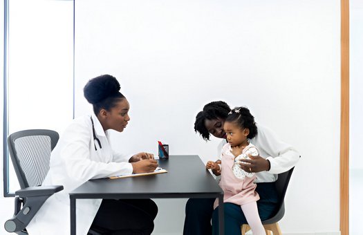 two kids playing at a table while parents are blurred in the background